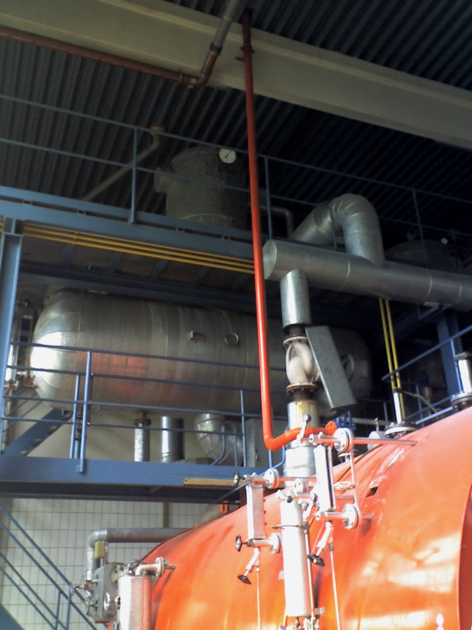 Shared deaerator and feedwater equipment serving two fire-tube boilers in a 2008 photograph